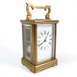 A brass cased carriage clock, with striking movement, the white enamel dial having Roman numerals,