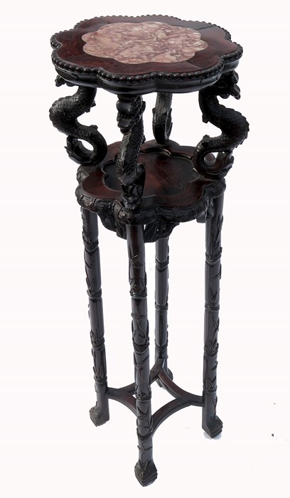 An Eastern design hardwood jardiniere stand, having marble top supported by stylised serpents,