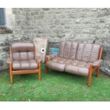 An Erkones leather and wood two seater settee, length 59ins, together with matching armchair, no