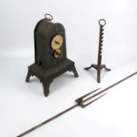 An antique clockwork spit or rotisserie turner, together with rod and spike to hold the meat and