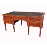 A 19th century mahogany writing desk, with ebonised line inlay, having a central frieze drawer,