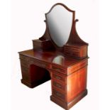 A 19th century mahogany dressing table, with shield shaped mirror flanked by two pairs of short