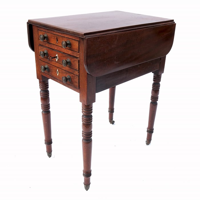 A 19th century work table, fitted with two drawers to one side and dummy drawers to the other,