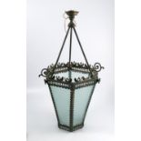 A metal hanging lamp shade, of hexagonal form, with leaf border over a pierced band, with frosted