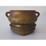 A Chinese Bronze Censer with lug handles and on stand, the base of the censer with apocryphal six