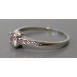 An 18ct White Gold Diamond Ring, principal stone c. .25ct, size O, 2.1g