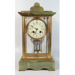 A French Onyx Four Glass Mantle Clock with enamel dial and mercury pendulum, 35 cm