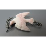 An Antique Coral Pendant in the form of The Dove of Peace bearing an olive branch mounted with