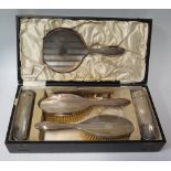 A George V Cased Silver Backed Six Part Mirror & Brush Set with engine turned decoration, Birmingham