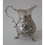 A George III Silver Cream Jug with repoussé decoration of swan and hair coursing, London 1748,