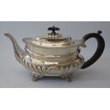 A George V Silver Teapot standing on lion paw feet with gadrooned waist and foliate border, London