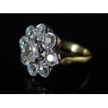 An 18ct Gold Diamond Flower Head Cluster Ring, the principal stone c. .75ct, size M, 5.5g