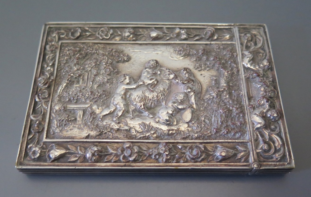 An Elkington Electrotype Card Case decorated with a central reserve of putti and ram in a foliate