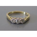 An 18ct Gold Three Stone Diamond Ring, size L, 2.9g