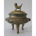 A Chinese Bronze Censer with mask handles and stylised foliate decoration, raised on three legs