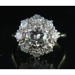 An 18ct Gold and Platinum Flower Head Cluster Ring, the principal stone c. 1.25ct, size L.5, 4.7g