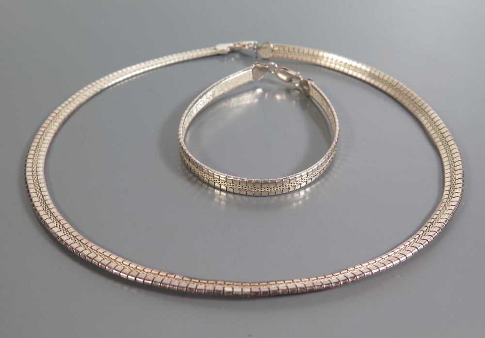A Cased Silver Necklace with matching bracelet and two other bracelets