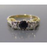 An 18ct Gold Sapphire and Diamond Three Stone Ring, size R, 3.8g