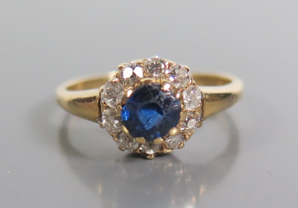 An 18ct Gold Sapphire and Diamond Cluster Ring, size N, 3.3g