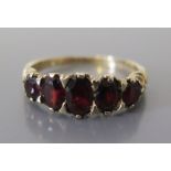 A 9ct Gold and Garnet Ring, size O.5, 2.3g