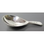 A Georgian Silver Caddy Spoon with bright cut decoration, date letter B, SH and magnifying glass A/