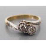 An 18ct Gold and Diamond Two Stone Crossover Ring, size L.5, 3.6g