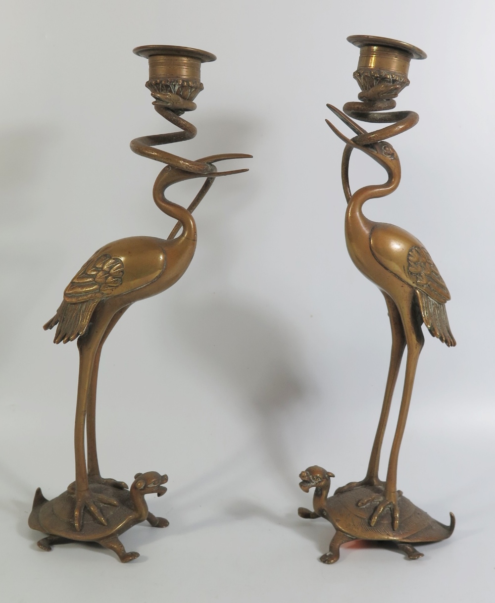 A Pair of Nineteenth Century Chinese Bronze Candlesticks in the form of storks standing on the backs