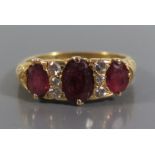 An 18ct Gold and Ruby Three Stone Ring, size K, 4.7g