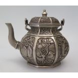 A Chinese Hexagonal White Metal Teapot decorated with various reserves of animals and plants,