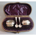 A Pair of Victorian Silver Salts and spoons with chased stylised foliate decoration and in