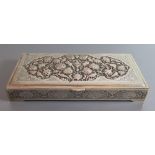 A Persian Silver Box with embossed bird and foliate decoration and further chased decoration, .84