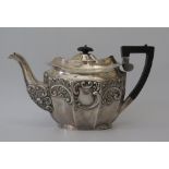 An Edward VII Silver Teapot of decagonal shape and embossed foliate scroll decoration, with marriage