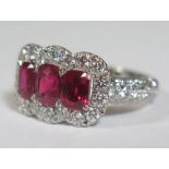 A Burmese Ruby Three Stone and Diamond Ring in a .950 Platinum Setting, with GCS Certificate