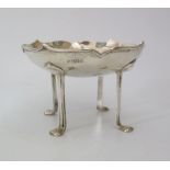 An Edward VII Arts & Crafts Silver Bowl of stylised floral form standing on four legs with pad