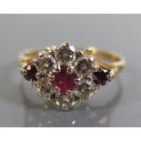 An 18ct Gold, Ruby and Diamond Flower Head Ring, size Q, 4.2g