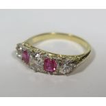 A Ruby and Diamond Five Stone Ring in a yellow gold setting, principal stone c. .65ct, size N, 4.1g