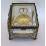 A Nineteenth Century Glass Pocket Watch Casket and two ivory brooches