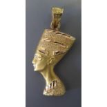 An Egyptian Yellow Metal Pendant in the form of a Pharaohs head, 2.6g