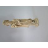 A Japanese Ivory Okimono of a lady carrying flowers, carved from a single piece