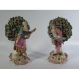 A Pair of Nineteenth Century Figurines of Musicians with bocage, gold anchor mark, 18cm