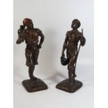 A Pair of Spelter Figurines of Middle Eastern Men bearing staffs and urns with bronzed patina and