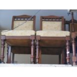 A Set of Four Edwardian Mahogany Side Chairs with overstuffed seats and padded backs