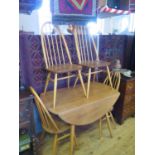 An Ercol Light Elm Drop Leaf Circular Table and Four Chairs