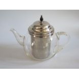 A Pyrex Teapot with silver plated mounts