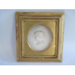 A Nineteenth Century Relief Plaster Bust in a gilt gesso frame