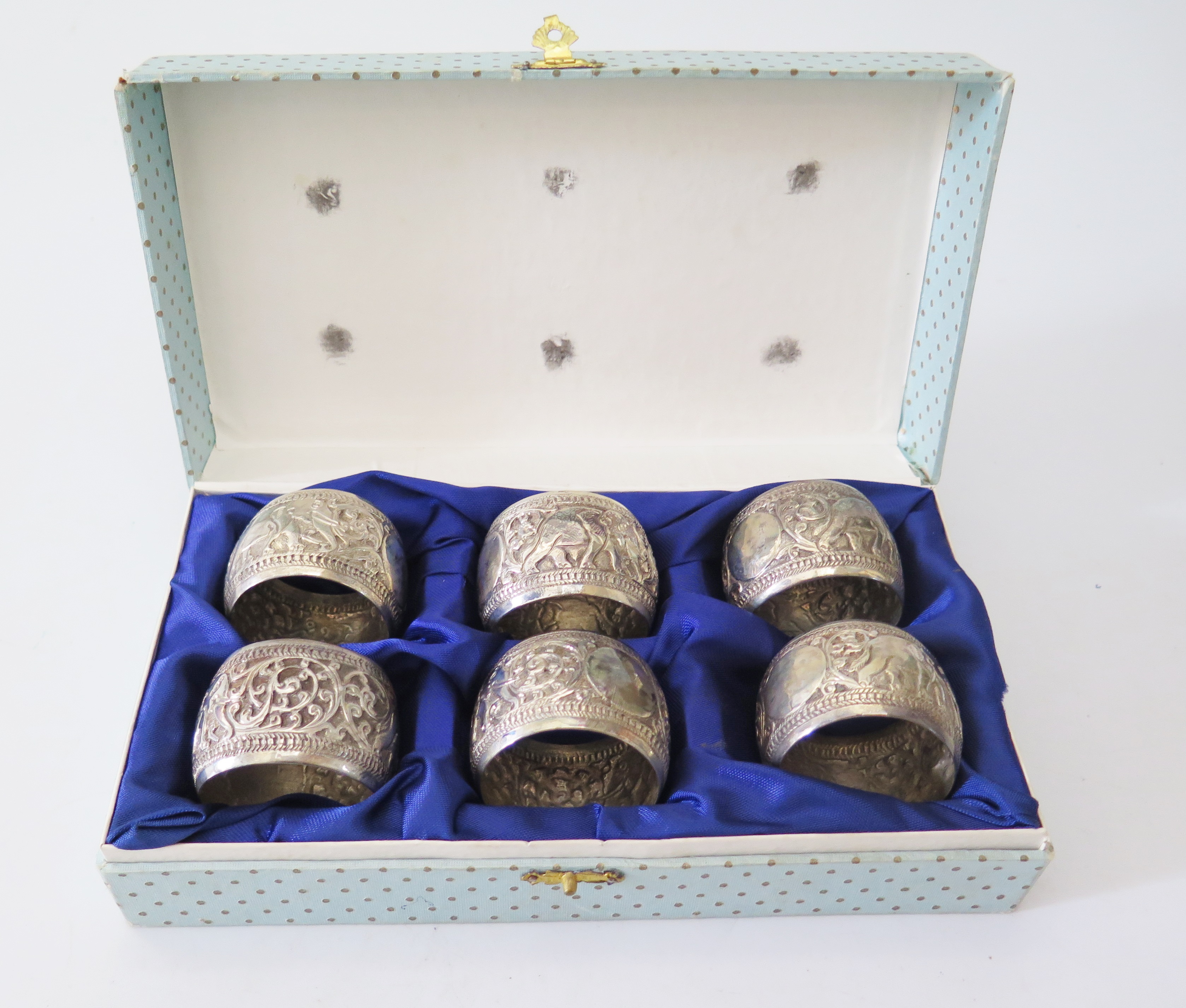 A Set of Six Indian Silver Napkin Rings decorated with elephants and scrolling foliate work, 120g