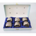 A Set of Six Indian Silver Napkin Rings decorated with elephants and scrolling foliate work, 120g