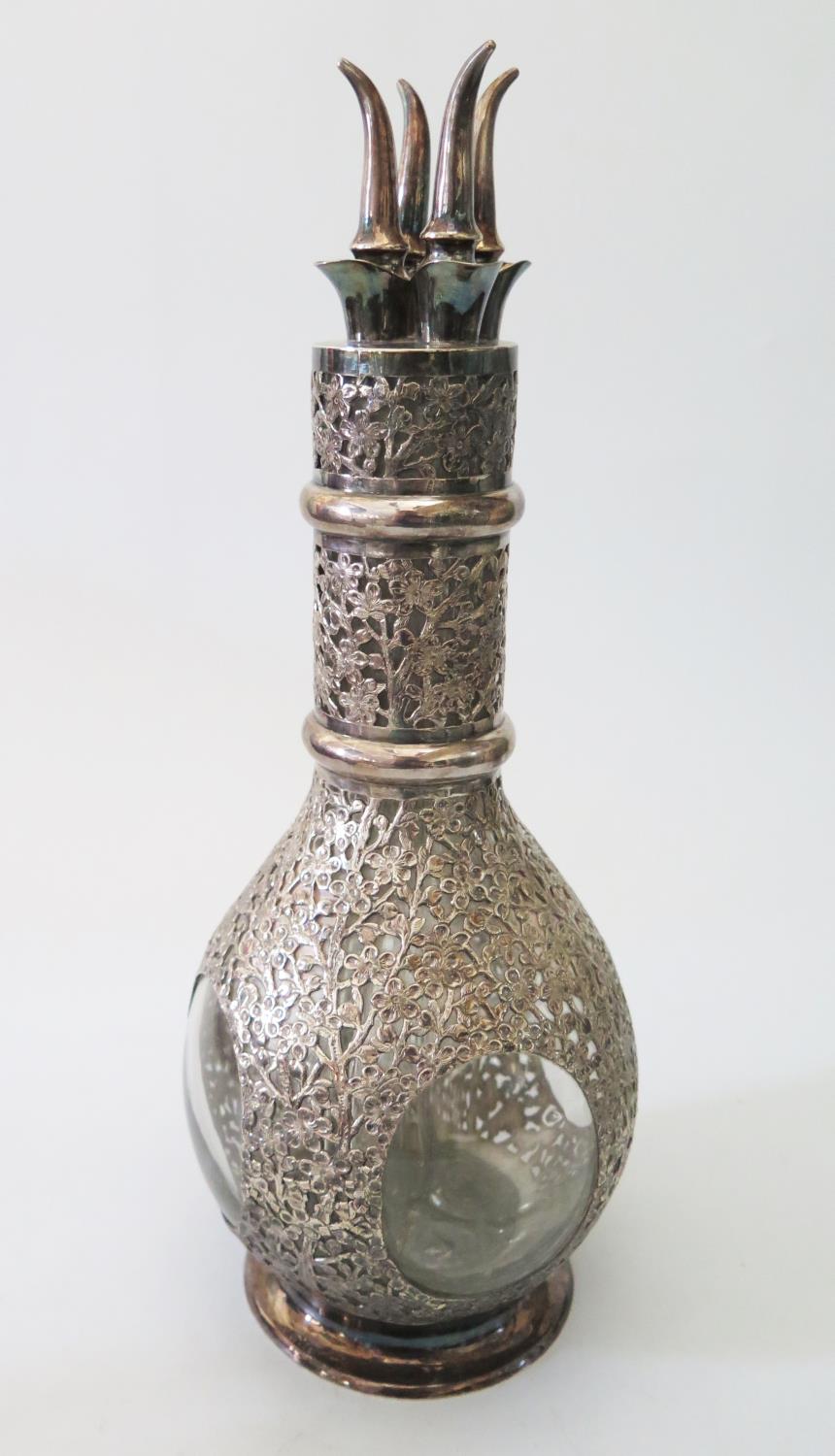 A Hong Kong Silver Mounted Decanter divided into four compartments, the overlay with pierced