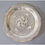 An Indian Silver Plate with stylised foliate decoration and central reserve of geese with entwined