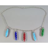A Silver Necklace decorated with five miniature enamel folding knives and button hooks